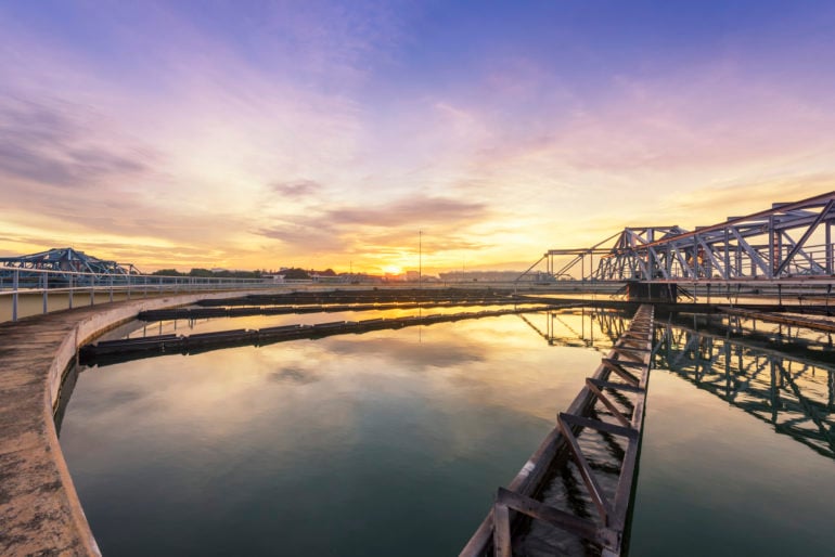 Water treatment clarifier tank during sunrise.